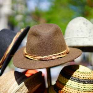 five hats on display with a brown hat in the middle
