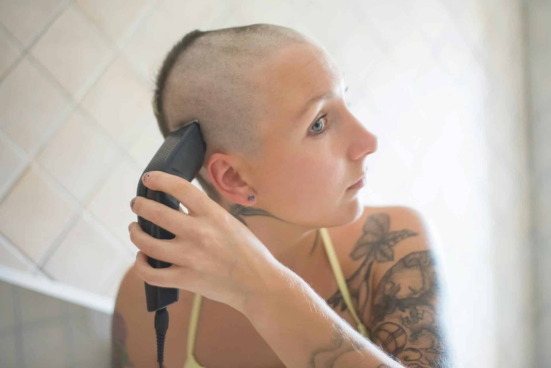 a woman shaving her head