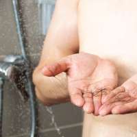 Close-up of a hands with hair fall in the shower